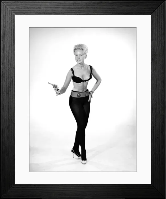 Framed Print : Model Brenda Bartlet dressed as Bond girl holding gun. October 1959 Framed Print : Model Brenda Bartlet dressed as Bond girl holding gun. October 1959