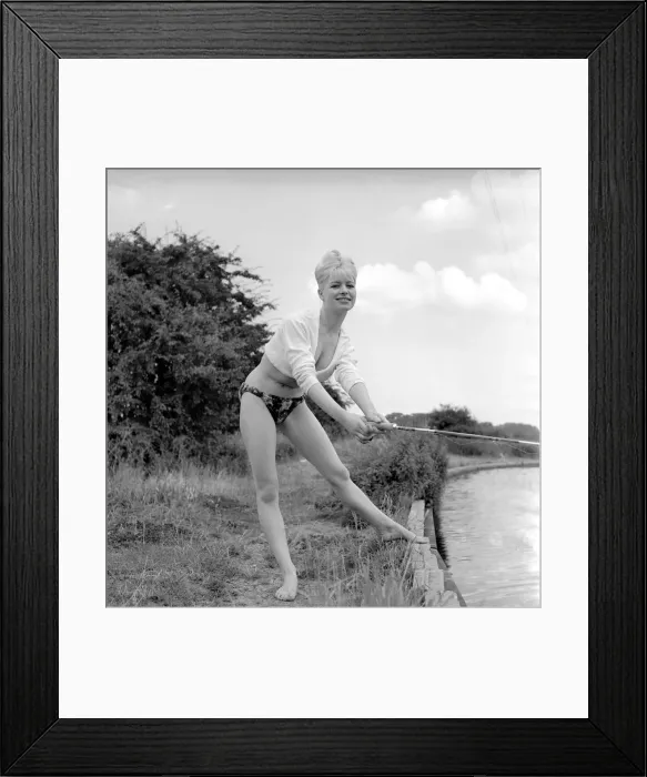 Framed Print : Clothing: Fashion: Beachwear: Model by the river bank fishing. August 1963 E490-017