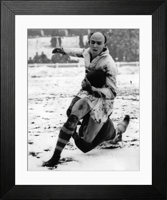Framed Print : Rugby player Bevan Brian evades a tackle whilst in action in the snow Framed Print : Rugby player Bevan Brian evades a tackle whilst in action in the snow