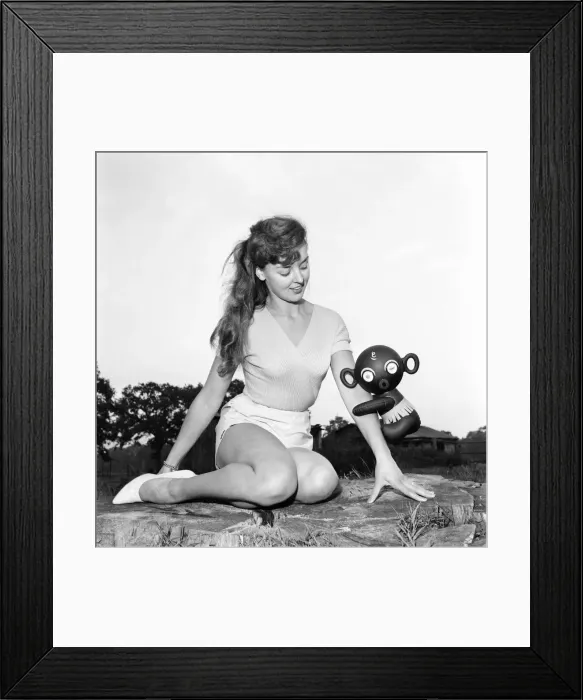 Framed Print : Model Kim Pearson seen here with inflatable alien toys. 1962 E422-003 Framed Print : Model Kim Pearson seen here with inflatable alien toys. 1962 E422-003