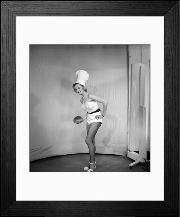 Framed Print : Woman wearing chefs hat holding loaf of bread. 1959 E61-004