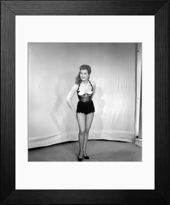 Framed Print : Showgirl in costume holding sword. 1959 E62-002