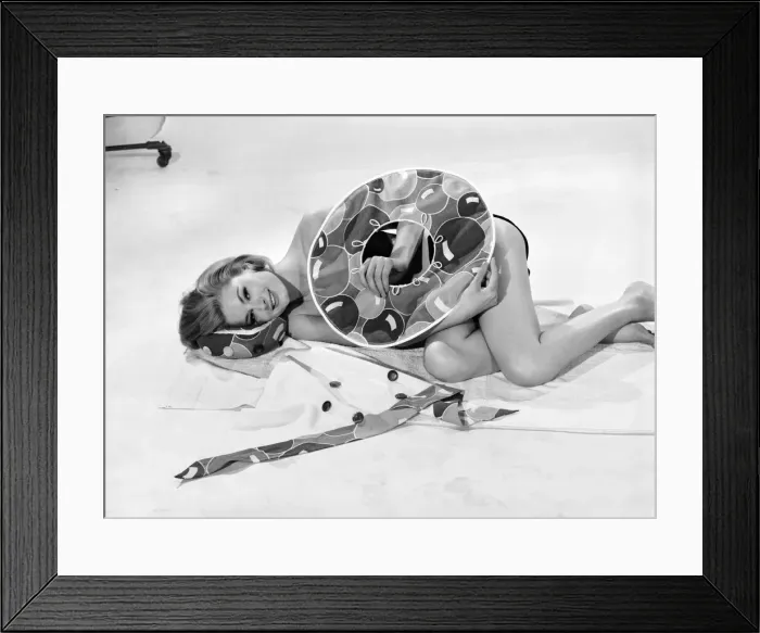 Framed Print : Model Margaret Lorraine wearing beach cushion hat. August 1962