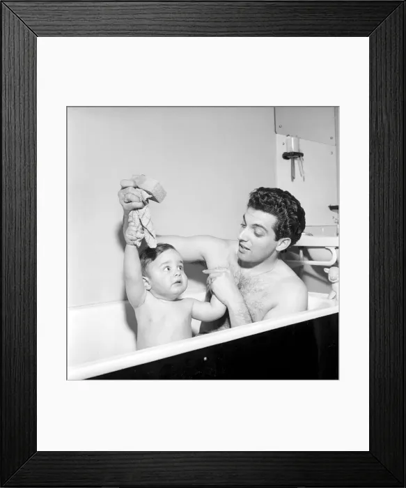 Framed Print : Singer Frankie Vaughan seen here taking a bath with his son David. Circa 1957 Framed Print : Singer Frankie Vaughan seen here taking a bath with his son David. Circa 1957