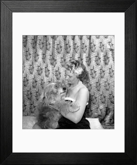 Framed Print : Woman showing affection to her pet dog: 1957 Framed Print : Woman showing affection to her pet dog: 1957