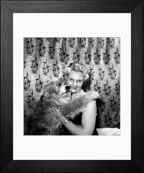 Framed Print : Woman showing affection to her pet dog: 1957 Framed Print : Woman showing affection to her pet dog: 1957