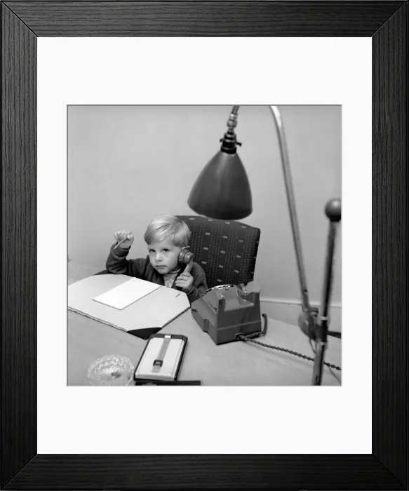 Framed Print : Office Junior: Two year old boy helps out at the offices of Theobald and son. 1957
