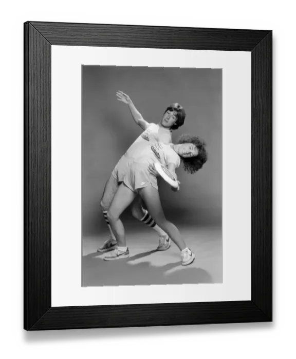 Framed Print : A man and woman performing exercises with a frisbee. June 1980 Framed Print : A man and woman performing exercises with a frisbee. June 1980