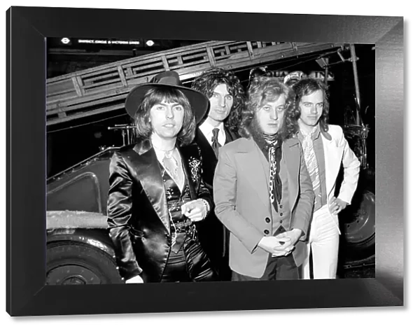 The Slade pop group on fire engine. L to R Dave Hill, Don Powell, Jimmy Lea, Noddy Holder