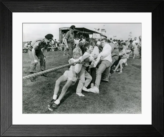 Framed Print : Soldiers encourage youngsters to get their backs into a tug-of-war in July 1987 Framed Print : Soldiers encourage youngsters to get their backs into a tug-of-war in July 1987