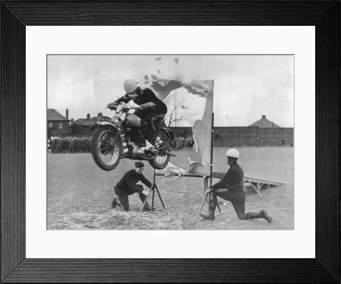 Framed Print : The jump through the paper hoop one of the many solo motorcycle tricks shown at Catterick Framed Print : The jump through the paper hoop one of the many solo motorcycle tricks shown at Catterick