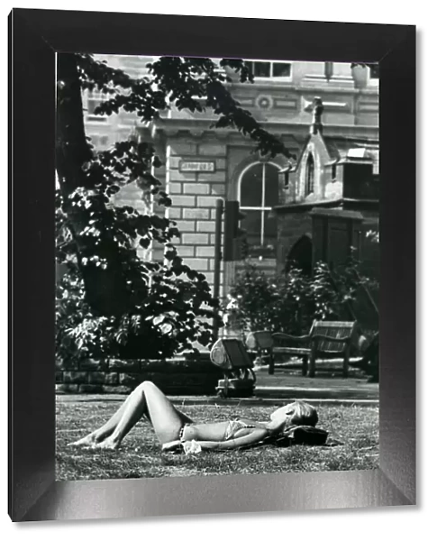 A girl sunbathes in St. Johns churchyard in Newcastle during the long hot summer in