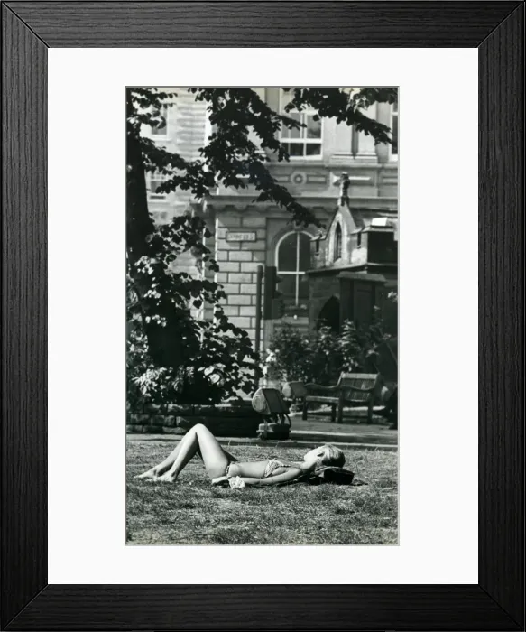 Framed Print : A girl sunbathes in St. Johns churchyard in Newcastle during the long hot summer in Framed Print : A girl sunbathes in St. Johns churchyard in Newcastle during the long hot summer in