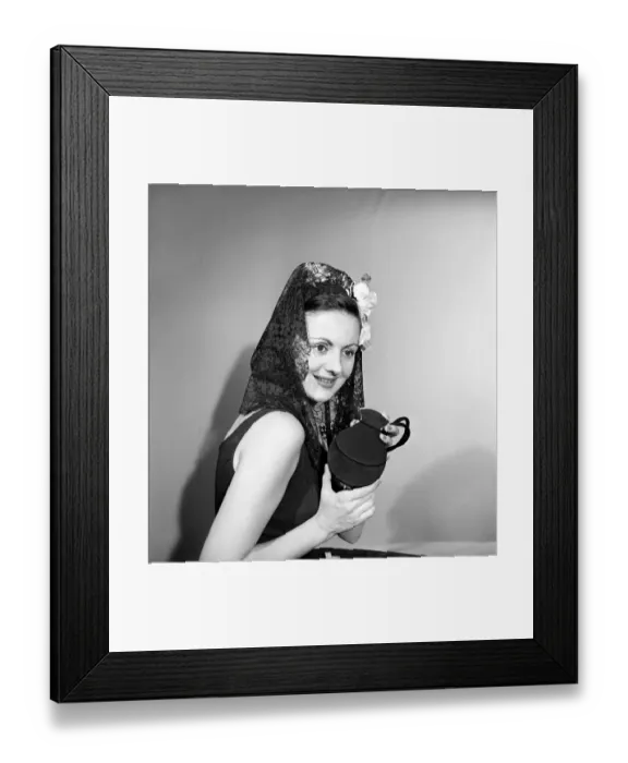 Framed Print : Woman dressed in the Spanish style holding compact. 1957 Framed Print : Woman dressed in the Spanish style holding compact. 1957