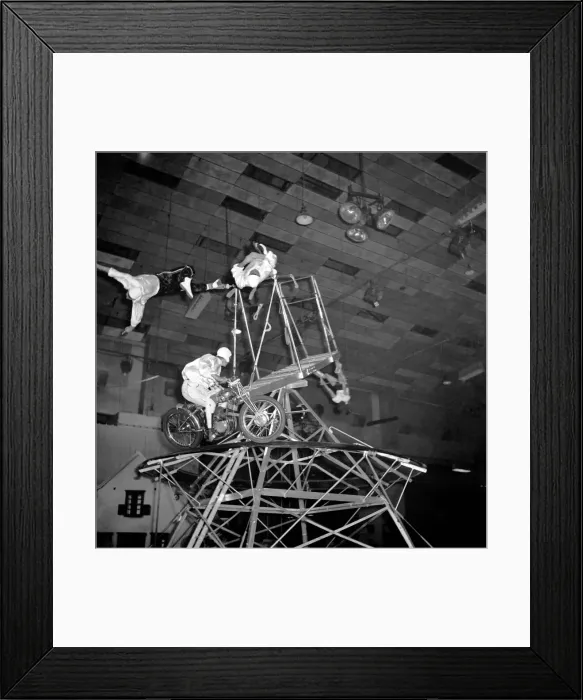 Framed Print : A circus novelty act based on the motorcycle wall of death combined with acrobats Framed Print : A circus novelty act based on the motorcycle wall of death combined with acrobats