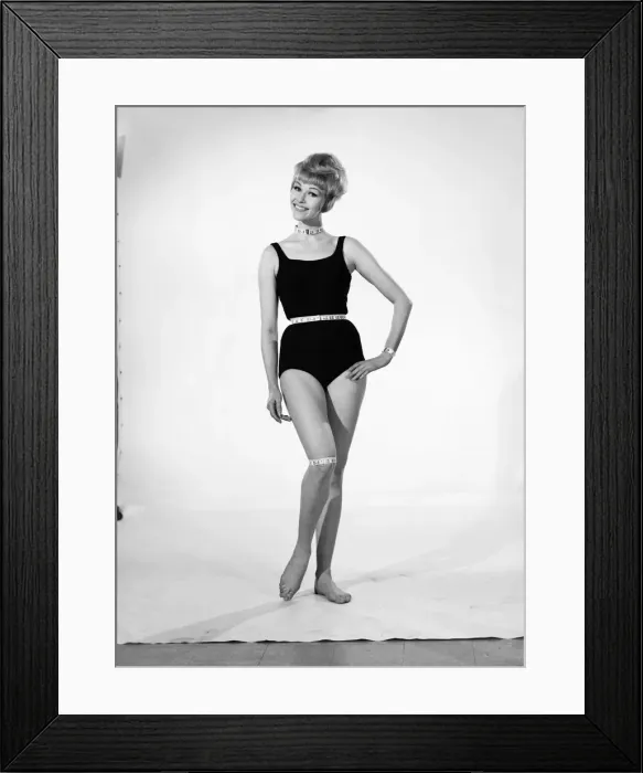 Framed Print : Clothing: Fashion: Beachwear. Woman wearing swimming costume and tape measure