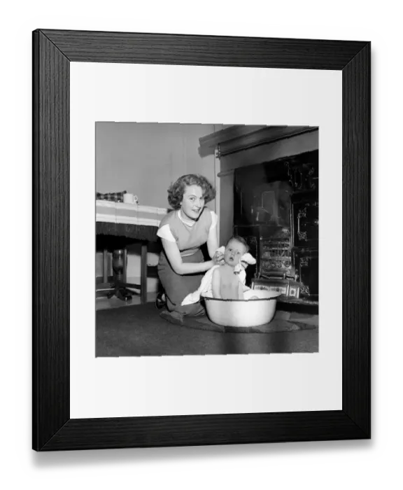 Framed Print : Family life: Mrs. Hull seen here bathing her son before giving him tea. 1954 A160-003