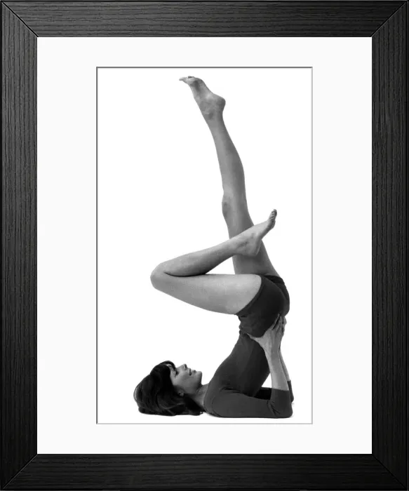 Framed Print : Woman stretching as she performs slimming exercises Circa 1975 P007921 Framed Print : Woman stretching as she performs slimming exercises Circa 1975 P007921