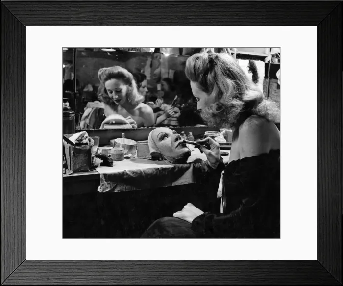 Framed Print : In the dressing rooms of the London Palladium we see Carol Trent making up her mask which