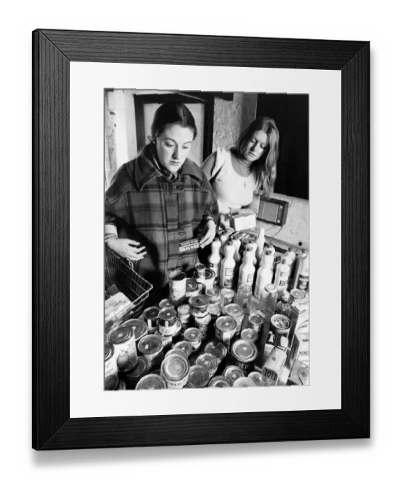 Framed Print : Woman shopping for cans of food, holding a basket. March 1977 P007931 Framed Print : Woman shopping for cans of food, holding a basket. March 1977 P007931