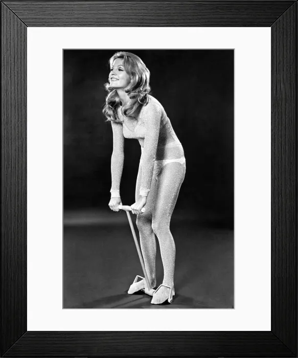 Framed Print : Woman performing the standing exercise for back and shoulders