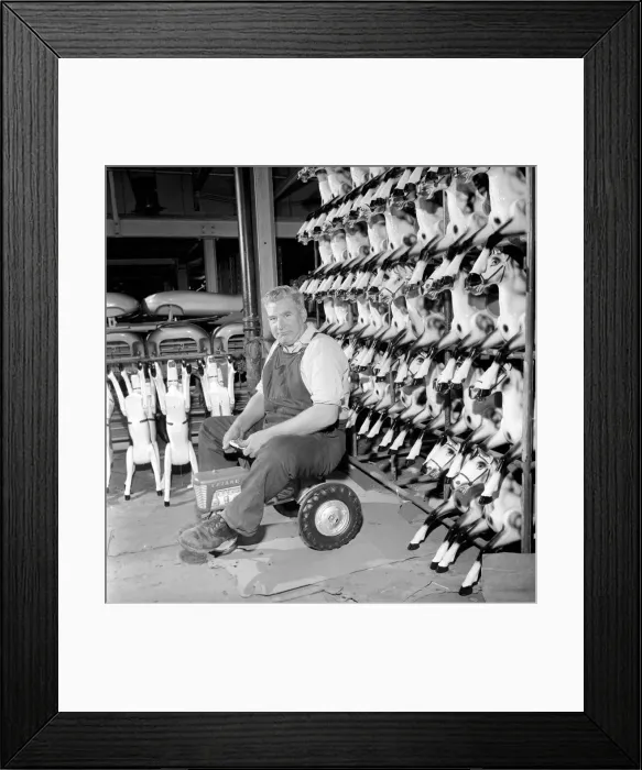 Framed Print : Toy tester: Man sitting on toy tractor at the Tri-ang factory in Merton South London 1965