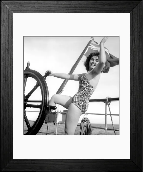 Framed Print : Julie Alexander models the latest swimwear whilst on a sail ship in the channel Framed Print : Julie Alexander models the latest swimwear whilst on a sail ship in the channel