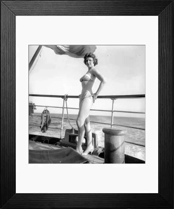 Framed Print : Julie Alexander models the latest swimwear whilst on a sail ship in the channel Framed Print : Julie Alexander models the latest swimwear whilst on a sail ship in the channel