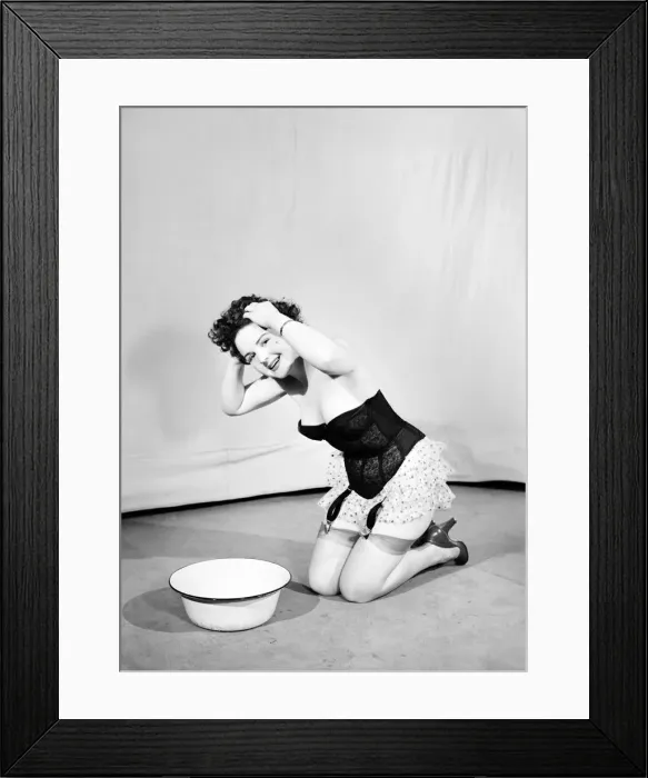 Framed Print : Woman wearing corsett washing hair. 1959