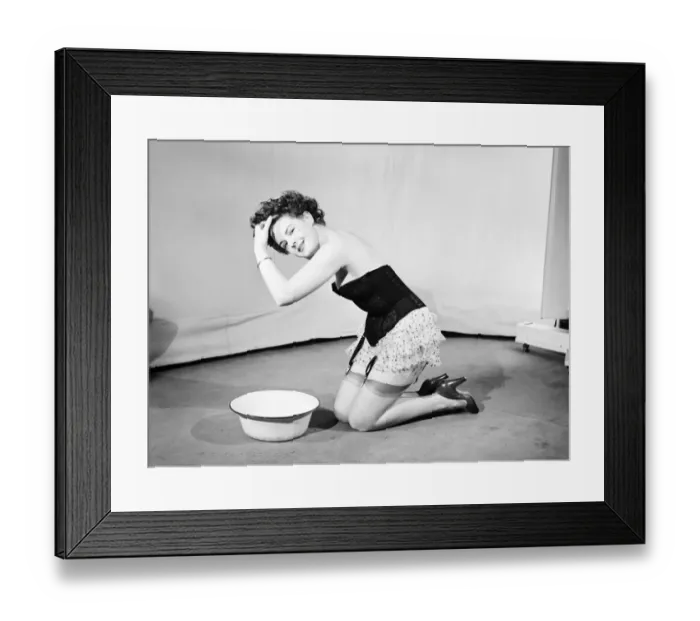 Framed Print : Woman wearing corsett washing hair. 1959 Framed Print : Woman wearing corsett washing hair. 1959