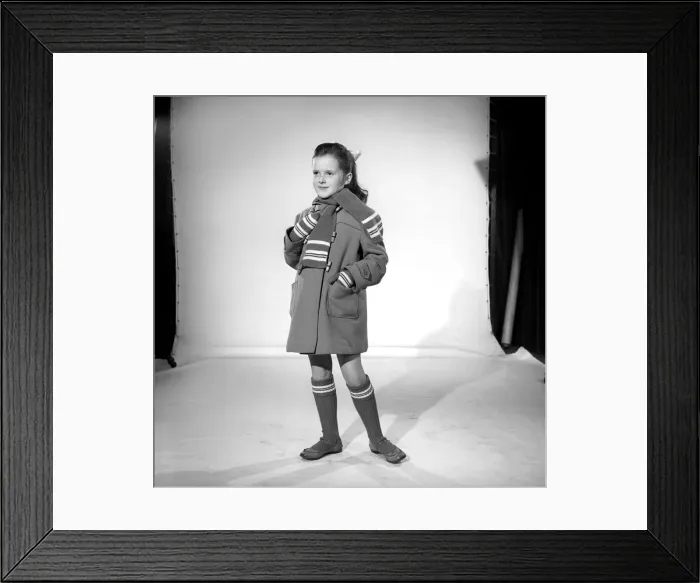Framed Print : Wrap up for winter: School girl wearing winter coat, scarf and socks. November 1956 B591 Framed Print : Wrap up for winter: School girl wearing winter coat, scarf and socks. November 1956 B591