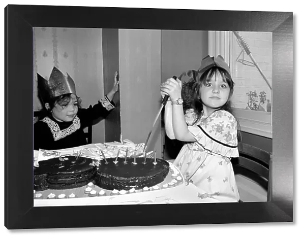 Childrens birthday party: The birthday girl cuts the cake. March 1981 PM 81-01186b-001