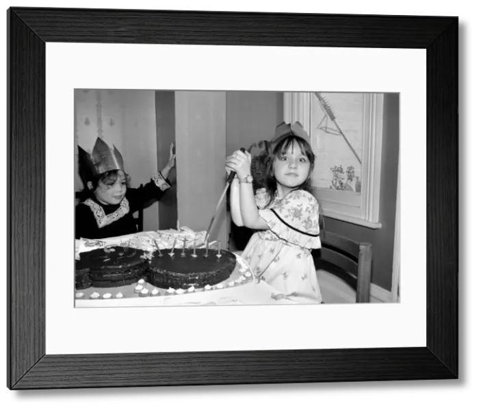 Framed Print : Childrens birthday party: The birthday girl cuts the cake. March 1981 PM 81-01186b-001