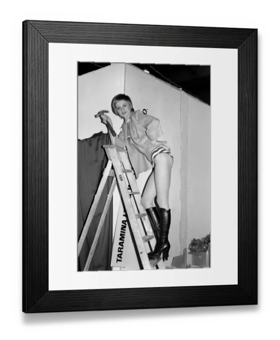 Framed Print : London Fashion Fair International: Model Laura Venner, 22 helping to fix up the stand for