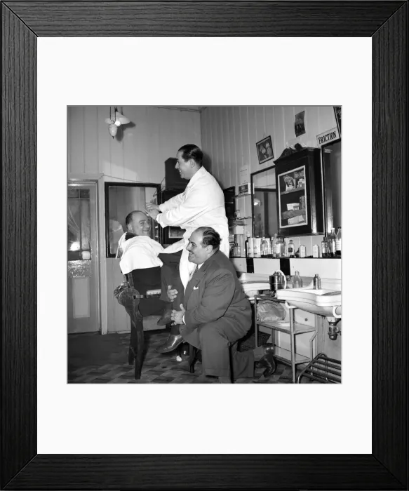 Framed Print : Mens Barbers Shop: Mr. Thomas the barber seen here having a joke with some of his