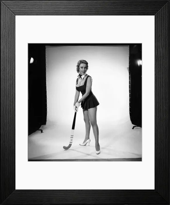 Framed Print : Rita Royce modelling sports kit with hockey stick. Circa 1959 Framed Print : Rita Royce modelling sports kit with hockey stick. Circa 1959