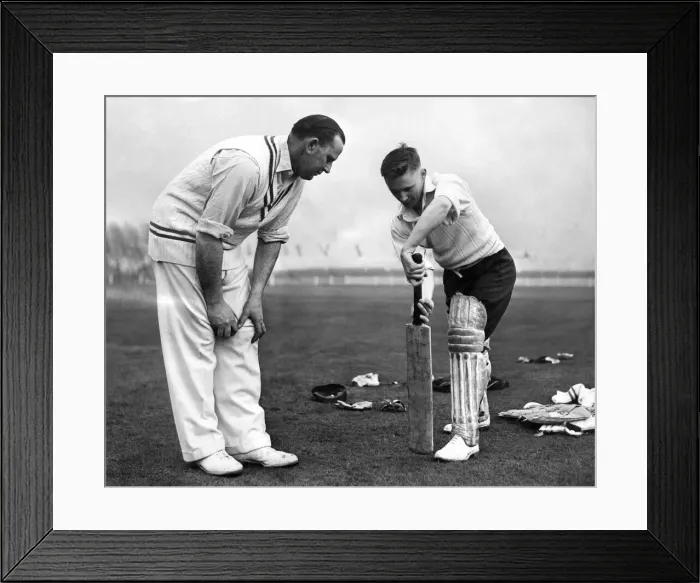Framed Print : Cecil Pepper gives 22 year old John David Bond of Radcliffe cricket club a few tips