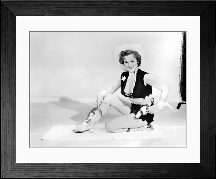 Framed Print : Model dressed as cow girl posing with pistol. Circa 1957 Framed Print : Model dressed as cow girl posing with pistol. Circa 1957