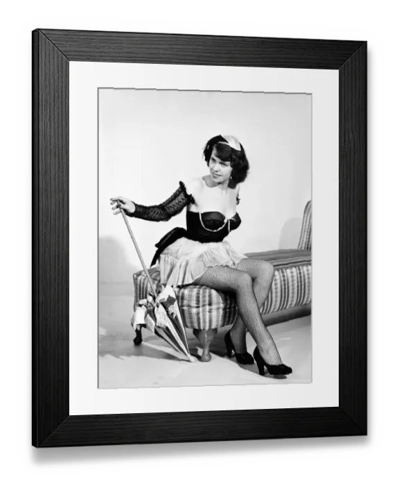 Framed Print : Show girl with umbrella. circa 1957