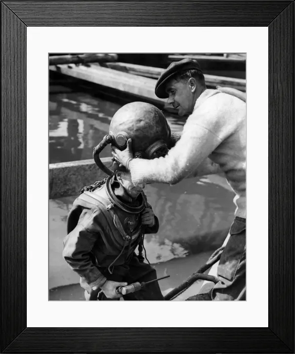 Framed Print : Diver Jack Ellis having his helmet put on. September 1949