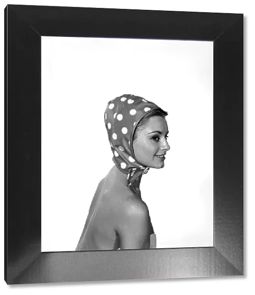 Woman wearing a polka dot hat hood. 1959