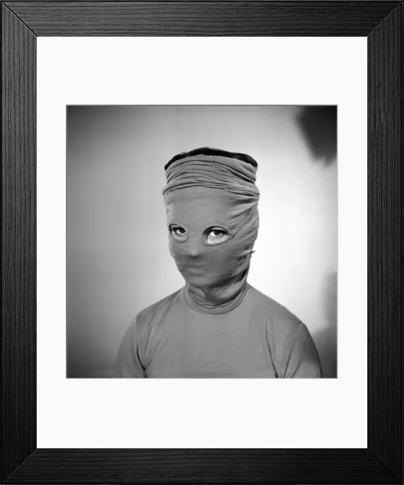 Framed Print : Model Mary Dixon wearing a hat that can be converted into a face mask. April 1956