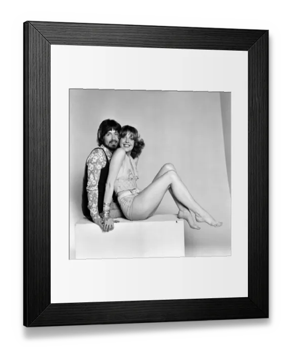 Framed Print : Couple wearing 1970s fashion. The woman wearing a matching top Framed Print : Couple wearing 1970s fashion. The woman wearing a matching top