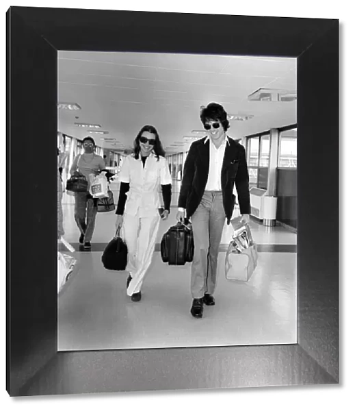 American actor Warren Beatty at Heathrow Airport with Michelle Phillips. May 1975