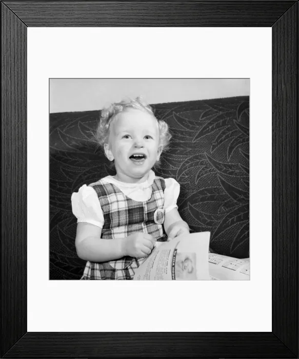 Framed Print : Small girl reading her book also seen with her dolls and violin. 1955 A138-004 Framed Print : Small girl reading her book also seen with her dolls and violin. 1955 A138-004