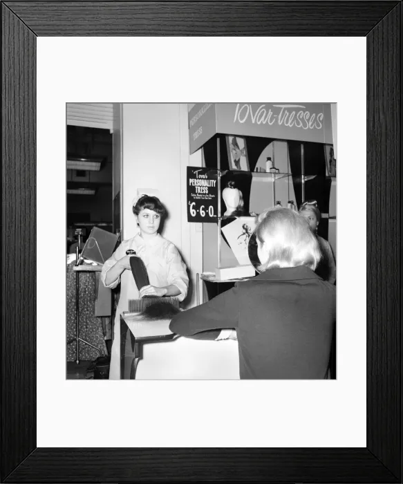 Framed Print : Woman at the beauty department of Selfridges store having a Tovar- tress attached to her
