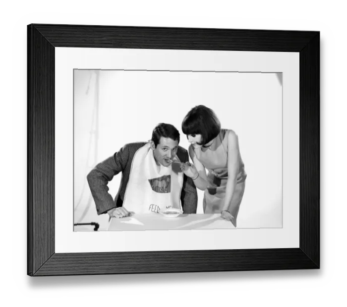 Framed Print : Man wearing feed me bib being fed by woman. Models: Michael Lester and Debbie Attwood