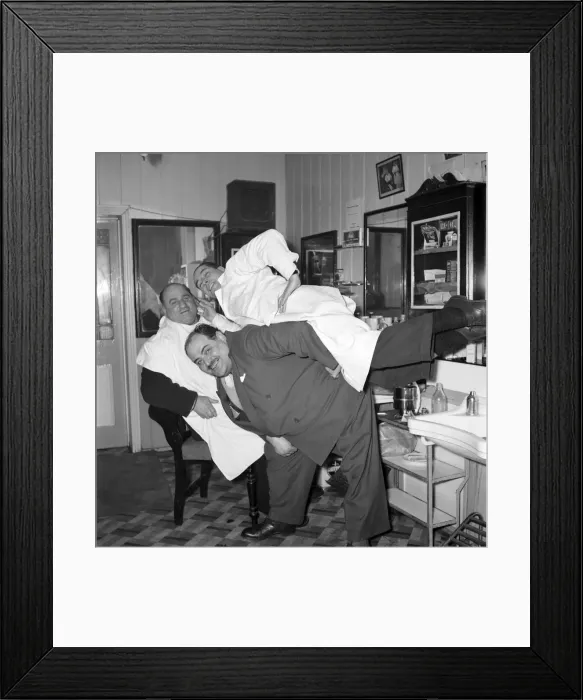 Framed Print : Mens Barbers Shop: Mr. Thomas the barber seen here having a joke with some of his