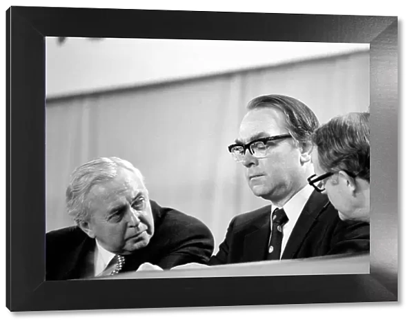 Prime mInister Harold Wilson talks to cabinet members during a debate on the Common