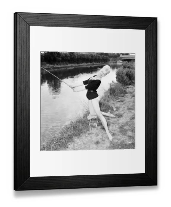 Framed Print : Clothing: Fashion: Beachwear: Model by the river bank fishing. August 1963 E490-008 Framed Print : Clothing: Fashion: Beachwear: Model by the river bank fishing. August 1963 E490-008